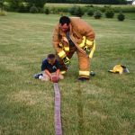 Teaching the young how to roll the hose “the fireman’s way”.